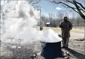  ?? ?? Rick Musselman, outdoor education director at Five Rivers MetroParks, stands next to a boiling pot of maple sap during Saturday’s maple sugaring event at Carriage Hill MetroPark.