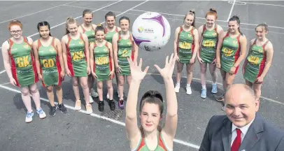  ??  ?? Jeremy Evans, senior manager at the Llanelli branch of Principali­ty Building Society, which has donated new kit to the members of the Ysgol y Strade netball team.