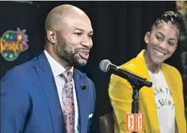  ?? Damian Dovarganes Associated Press ?? NEW SPARKS coach Derek Fisher is joined by forward Candace Parker during a news conference. Parker, a former league MVP, supported the hiring of Fisher.