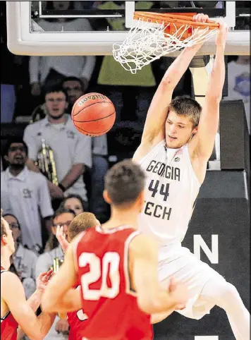  ?? CURTIS COMPTON / CCOMPTON@AJC.COM ?? Center Ben Lammers, who had his 15th double-double of the season, slams for two over Belmont defenders Sunday in Atlanta.