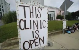  ?? ROGELIO V. SOLIS — THE ASSOCIATED PRESS ?? A posted sign outside the Jackson Women's Health Organizati­on clinic assures potential patients that it is open Sunday in Jackson, Miss.