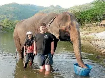  ??  ?? Jack Lanting and Elephant Nature Park founder Lek Chailert, in the river at the park after he rescued an elephant called Sook Sai.