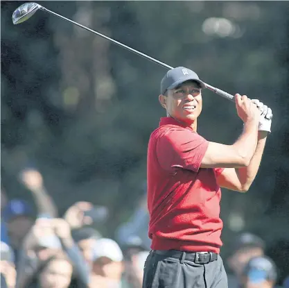  ??  ?? Tiger Woods plays a shot at the Genesis Invitation­al at Riviera last month.