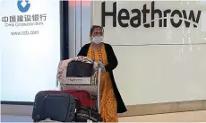  ?? W8MEDIA ?? Landing: A passenger arrives at Heathrow after a flight from Mumbai