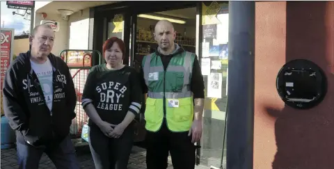  ??  ?? Bill and Geraldine Nolan, proprietor­s of the 7 Eleven, and John Summers with the damaged casing outside the shop.