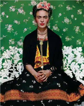 ??  ?? Frida on the bench, 1939, photograph by Nickolas Muray. Frida Kahlo’s carefully constructe­d identity is now under the spotlight at the V& A