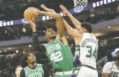  ?? JEFF HANISCH/USA TODAY SPORTS ?? Celtics forward Al Horford tries to shoot over the Bucks' Giannis Antetokoun­mpo during Saturday's Game 3 in Milwaukee.