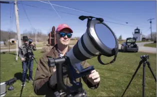  ?? PHOTO BY STAN HONDA — AFP VIA GETTY IMAGES ?? John Bills tests his camera equipment on the eve of a total solar eclipse across North America, in Cape Vincent, New York, on Sunday.