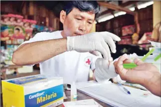  ?? AFP ?? A village malaria worker takes a blood test near the Thai border in 2012.