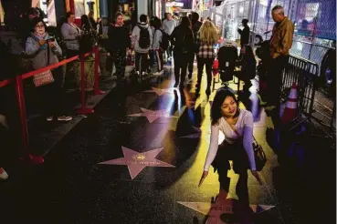  ?? Kent Nishimura / Los Angeles Times ?? Tourists take pictures on Hollywood Boulevard. A dispute between federal agencies over how to calculate visitation numbers for internatio­nal travelers has been settled, with numbers showing a 0.7 percent increase in 2017 over the previous year. Before Donald Trump’s election, the number of internatio­nal visitors had been climbing steadily.