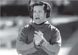  ?? CHRIS SEWARD AP ?? UM coach Manny Diaz encourages his team during the first half in the Hurricanes’ victory against Duke on Saturday. Diaz’s future with the team is uncertain after a 7-5 season.