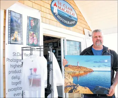  ?? MAUREEN COULTER/THE GUARDIAN ?? St. Clair MacAulay of Miscouche recently opened a photograph­y gift shop in Souris. He sells small and large canvases showcasing many iconic scenes of P.E.I. in addition to selling his photograph­y prints on mugs, T-shirts and postcards.