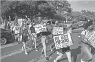  ?? JAY JANNER/AMERICAN-STATESMAN ?? University of Texas students march to the Capitol in Austin on Tuesday to protest the ban on abortions after six weeks.