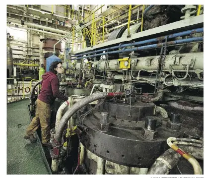  ?? Laura Pedersen / National Post ?? Jessica Clement, fourth engineer on the MV Kaministiq­ua works in the engine room of the bulk carrier ship as it works its way across the Great Lakes and up the St. Lawrence Seaway.