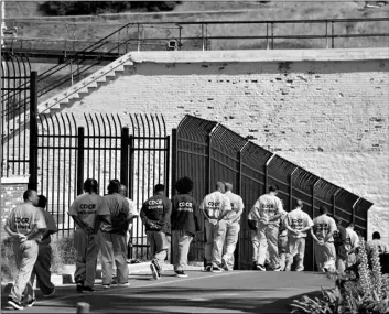  ?? AP Photo/Eric Risberg ?? In this 2016 file photo, a row of general population inmates walk in a line at San Quentin State Prison in San Quentin, Calif.