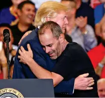 ??  ?? Close: Mr Huber hugs Donald Trump on stage