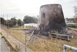  ??  ?? SHELL. Mostert’s Mill, a familiar site to many Capetonian­s, has been destroyed. The sail lies on the ground.