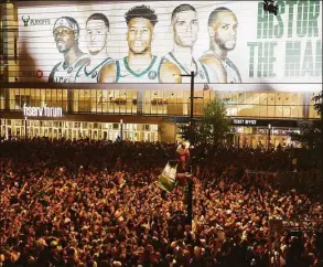  ?? Jeffrey Phelps / Associated Press ?? Fans cheer after the Bucks defeated the Suns in Game 6 of the NBA Finals on July 20 in Milwaukee.