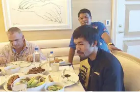  ?? Photo from Neri’s Facebook ?? Manny Pacquiao is seen dining with adviser Michael Koncz (right) and assistant trainer Nonoy Neri.