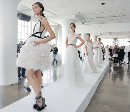  ?? — PHOTOS: THE ASSOCIATED PRESS ?? White was accented with black at Marchesa’s spring 2018 bridal show.