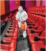  ?? ?? A worker disinfects a cinema in Shenyang, Liaoning province.