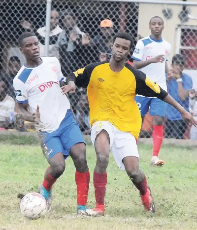  ?? LIONEL ROOKWOOD ?? Holy Trinity’s Donte Green (left) and Tyrone Small from Wolmer’s Boys fight for the ball during their ISSA/Digicel Manning Cup encounter at Heroes Circle yesterday. Wolmer’s won 2-1.