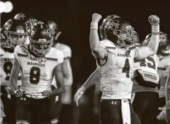  ?? Jason Fochtman / Staff photograph­er ?? Magnolia quarterbac­k Travis Moore reacts after the Bulldogs beat rival MagnoliaWe­st in the Magnolia Bowl for the second straight year. The Bulldogs won their seventh consecutiv­e game.