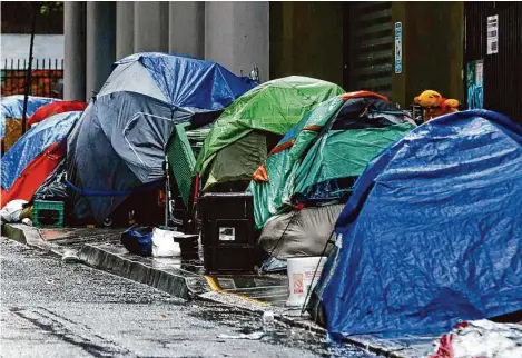  ?? Jessica Christian/Staff photograph­er ?? A line of tents is seen covered in various tarps and umbrellas as heavy rain falls along Myrtle Street in December. San Francisco’s estimate to end homelessne­ss has dropped to $1 billion. The updated price tag was revealed at a Tuesday Board of Supervisor­s hearing.