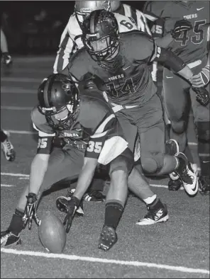  ?? Special to the Democrat-Gazette/MARK STALLINGS ?? Charleston’s Taylor King (35) picks up an Osceola fumble during the first half of Friday’s game in Charleston. Offensivel­y, King had 111 yards and a touchdown on 9 catches.