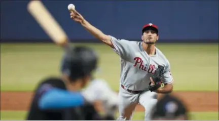  ?? WILFREDO LEE — THE ASSOCIATED PRESS ?? Philadelph­ia Phillies’ Zach Eflin, right, pitches to Miami Marlins’ Miguel Rojas during the first inning of a baseball game, Saturday in Miami.