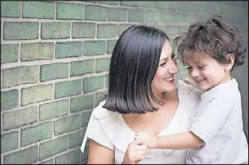  ?? CONTRIBUTE­D BY NANCY BOROWICK ?? Lauren Smith Brody, author of “The Fifth Trimester,” poses with one of her sons.