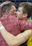  ?? Steph Chambers/Post-Gazette ?? North Catholic coach Dave DeGregorio celebrates with his son, Isaac,after beating Lincoln Park, 65-56.