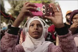  ?? MAYA ALLERUZZO — THE ASSOCIATED PRESS ?? A teenager films Sudanese dancers on her mobile phone during an event marking the U.N.’s Internatio­nal Refugee Day in Cairo, Egypt.