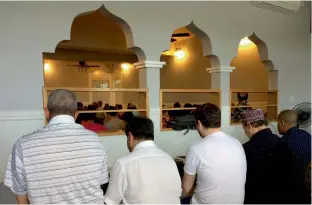  ?? — AP ?? In this photo taken on March 10, men gather for afternoon prayers at the Muslim Associatio­n of Hawaii in Honolulu