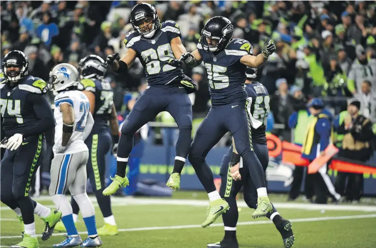  ?? — GETTY IMAGES ?? Doug Baldwin, centre, of the Seattle Seahawks celebrates with Jermaine Kearse after scoring a touchdown during Saturday’s game against the Detroit Lions.