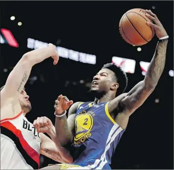  ?? Ted S. Warren Associated Press ?? GOLDEN STATE forward Jordan Bell, going up for a shot against Portland’s Meyers Leonard, is one of the Warriors’ reserves who raised their game in the absence of Kevin Durant during the playoffs.