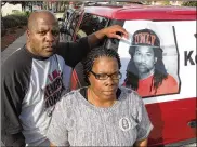  ?? RUSS BYNUM / AP ?? Kenneth and Jacquelyn Johnson stand next to a banner of their late son, Kendrick Johnson, whose body was found inside a rolled-up gym mat in 2013.