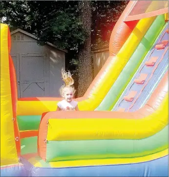  ?? Lynn Atkins/The Weekly Vista ?? True Love tries out the inflatable obstacle course that was set up behind the library as part of the kick off for the Summer Reading Program on Wednesday last week.