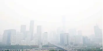  ?? — AFP file photo ?? A general view shows the central business district on a polluted day in Beijing.