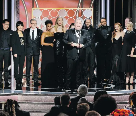  ?? NBC ?? Writer-producer Bruce Miller accepts the award for best TV drama series along with the cast and crew of The Handmaid’s Tale on Sunday night at the 75th annual Golden Globe Awards. The series is based on Canadian Margaret Atwood’s book of the same name.