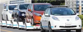  ??  ?? YOKOHAMA: Nissan Motor Co ‘S “Leaf”, with no one inside, pulls a trailer with three other Leafs on it, during a demonstrat­ion of the automaker’s Intelligen­t Vehicle Towing system at Nissan Oppama plant. — AP