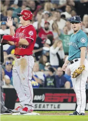  ?? LINDSEY WASSON/GETTY IMAGES ?? Neither Mike Trout’s Los Angeles Angels nor Kyle Seager’s Seattle Mariners have a positive run differenti­al, and both teams are right around .500 — but they’re both in the playoff hunt.