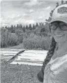  ??  ?? Prairie Hill Waldorf School teacher Lindsey Earle and her helpers cut wood to construct an outdoor classroom in Pewaukee, Wis.