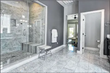  ?? Lisa Paquette Tourfactor­y ?? The spacious master bath at 10373 Burensburg Ave. in Summerlin has a steam shower, separate sinks and vanities, a makeup area and a throwback pedestal claw-foot tub.