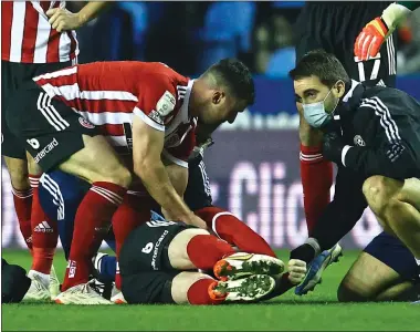  ?? ?? HELPING HANDS: Sheffield United have insisted Fleck’s collapse at Reading was not related to the vaccine