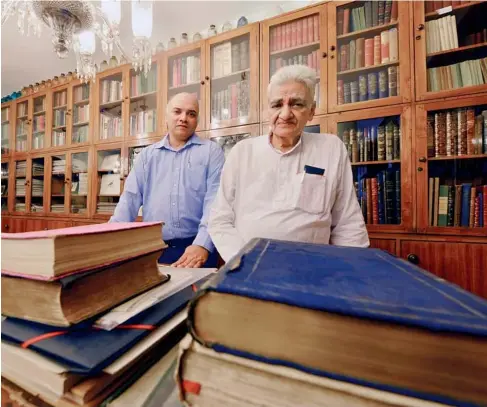  ?? CHANDRADEE­P KUMAR/
www. indiatoday­images. com ?? Book Warm: Rajiv with his father GC Jain n at the shop; ( left) A book signed by Pablo Picasso