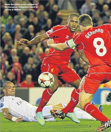  ?? Picture: Getty. ?? Karim Benzema scores for Real as the European champions eased to victory at Anfield.