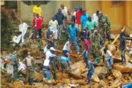  ?? ASSOCIATED PRESS FILE PHOTO ?? Volunteers search Tuesday for bodies at the site of heavy flooding and mudslides in Regent, just outside Sierra Leone’s capital, Freetown.