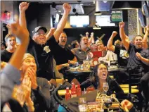  ?? Andrea Cornejo ?? Vegas Golden Knights fans at Mackenzie River Pizza react after the team scored in Monday’s Game 2 victory over the Winnipeg Jets.