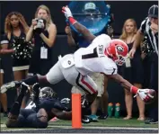  ?? Mark Humphrey / The Associated Press ?? Georgia running back D’Andre Swift (right) reaches past Vanderbilt safety Ryan White to score a touchdown.